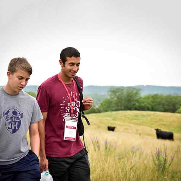 BCYC participants hiking with cows in the background